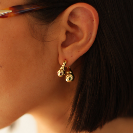 Aretes esculturales con forma orgánica.